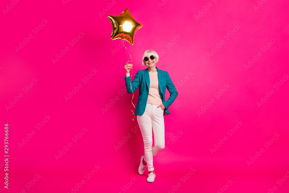 Full length body size view of nice-looking attractive well-dressed cheerful gray-haired lady holding balloon enjoying free time isolated on bright vivid shine vibrant pink fuchsia color background Full length body size view of nice-looking attractive well-dressed cheerful gray-haired lady holding balloon enjoying free time isolated on bright vivid shine vibrant pink fuchsia color background