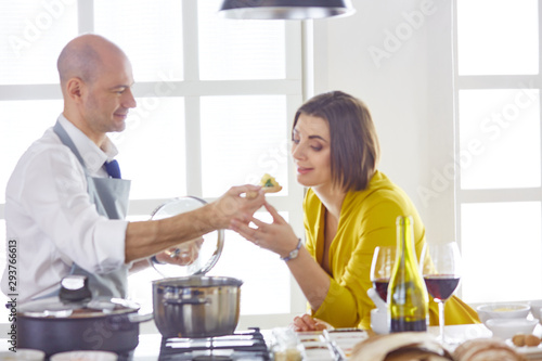 Smiling young couple cooking food in the kitchen