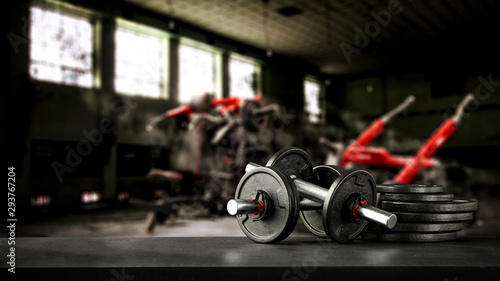 Gym interior and dumbbells on black desk with free space for your decoration. © magdal3na