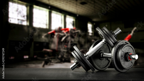 Gym interior and dumbbells on black desk with free space for your decoration. 