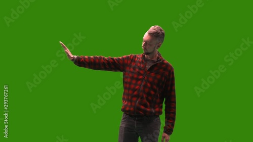 Male model on green screen  hand to the left to dissaprove something. Easy chroma keying by just one click is prepared. photo