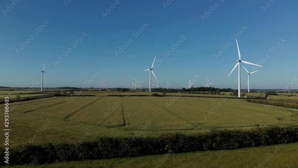 Wind Farm Northamptonshire In Green Crop Fields Blue Sky Summer Aerial 4K Wind Farm Northamptonshire In Green Crop Fields Blue Sky Summer Aerial 4K