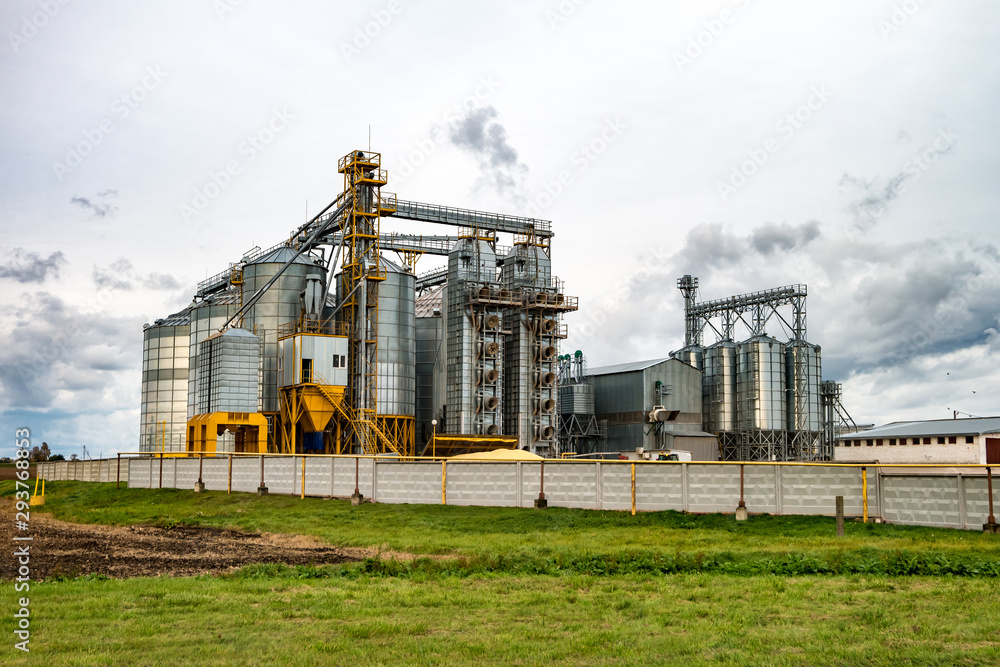 agro-processing plant for processing and silos for drying cleaning and storage of agricultural products, flour, cereals and grain with beautiful clouds agro-processing plant for processing and silos for drying cleaning and storage of agricultural products, flour, cereals and grain with beautiful clouds
