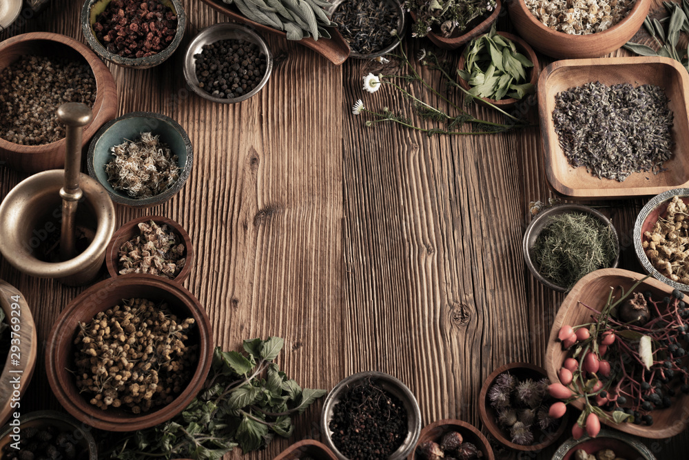Spices theme. Collection of spices in bowls on wooden rustic table. Place for text or typography. Spices theme. Collection of spices in bowls on wooden rustic table. Place for text or typography.