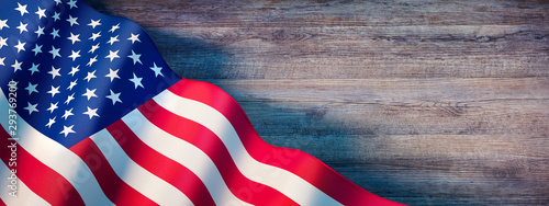 Fototapeta Naklejka Na Ścianę i Meble -  Waving flag of United States - Flag of America on wooden background