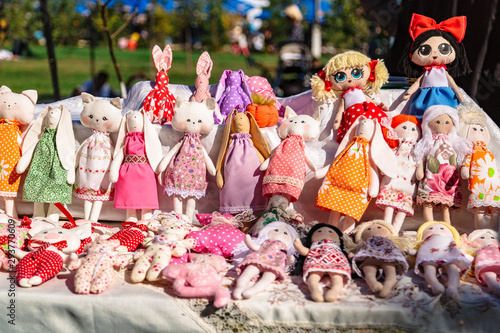 Billede på lærred Large assortment of rag animal dolls on fall fair