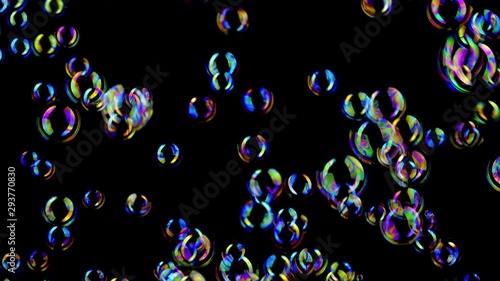 Colorful soap bubbles fly across black background.