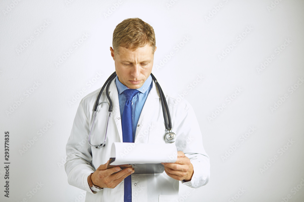 Young confident doctor in a white coat with a stethoscope