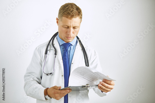 Young confident doctor in a white coat with a stethoscope