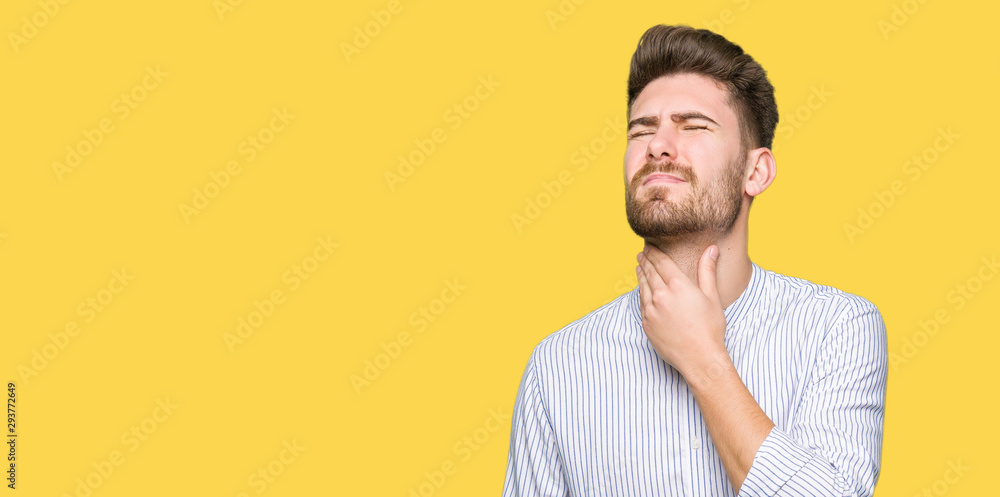 Young handsome man Touching painful neck, sore throat for flu, clod and infection Young handsome man Touching painful neck, sore throat for flu, clod and infection