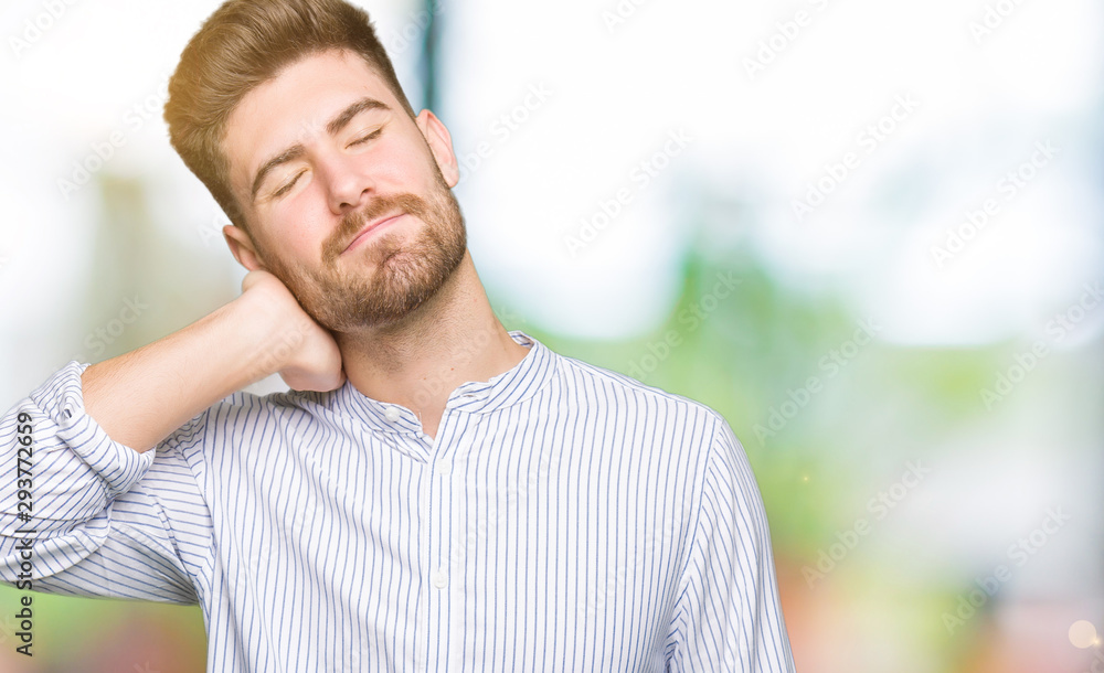 Young handsome man Suffering of neck ache injury, touching neck with hand, muscular pain Young handsome man Suffering of neck ache injury, touching neck with hand, muscular pain