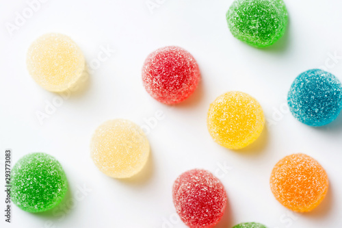 Foto Colorful yellow red orange green gummy jelly candies coated with sugar on white background