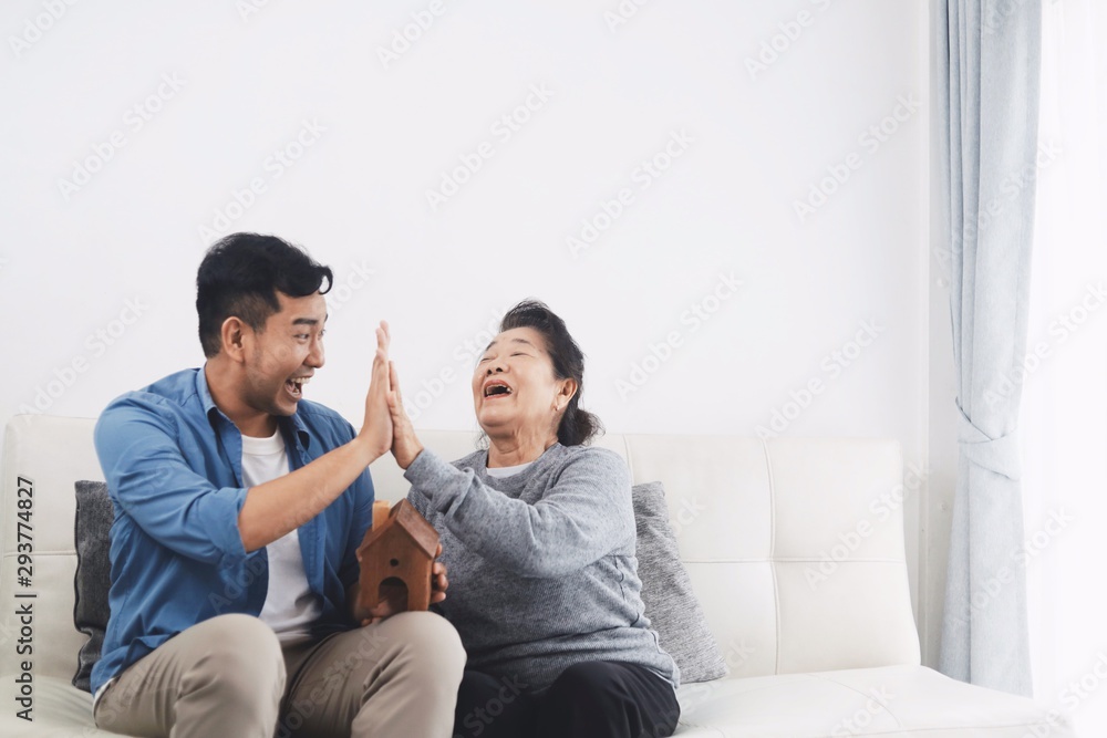 Mother and son playing together on sofa at home