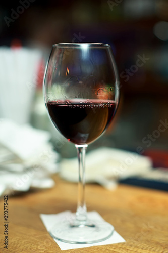 glass of red wine on table in bar