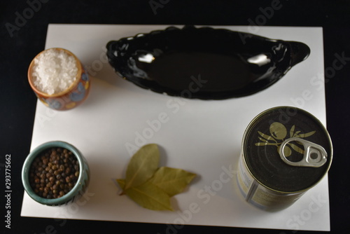 olives and spices on a black background