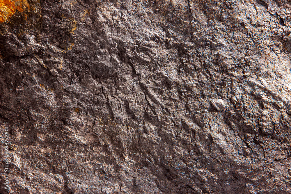 Stone background, rock wall backdrop with rough texture. Abstract, grungy and textured surface of stone material. Nature detail of rocks.