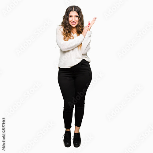 Young beautiful woman wearing white sweater Clapping and applauding happy and joyful, smiling proud hands together