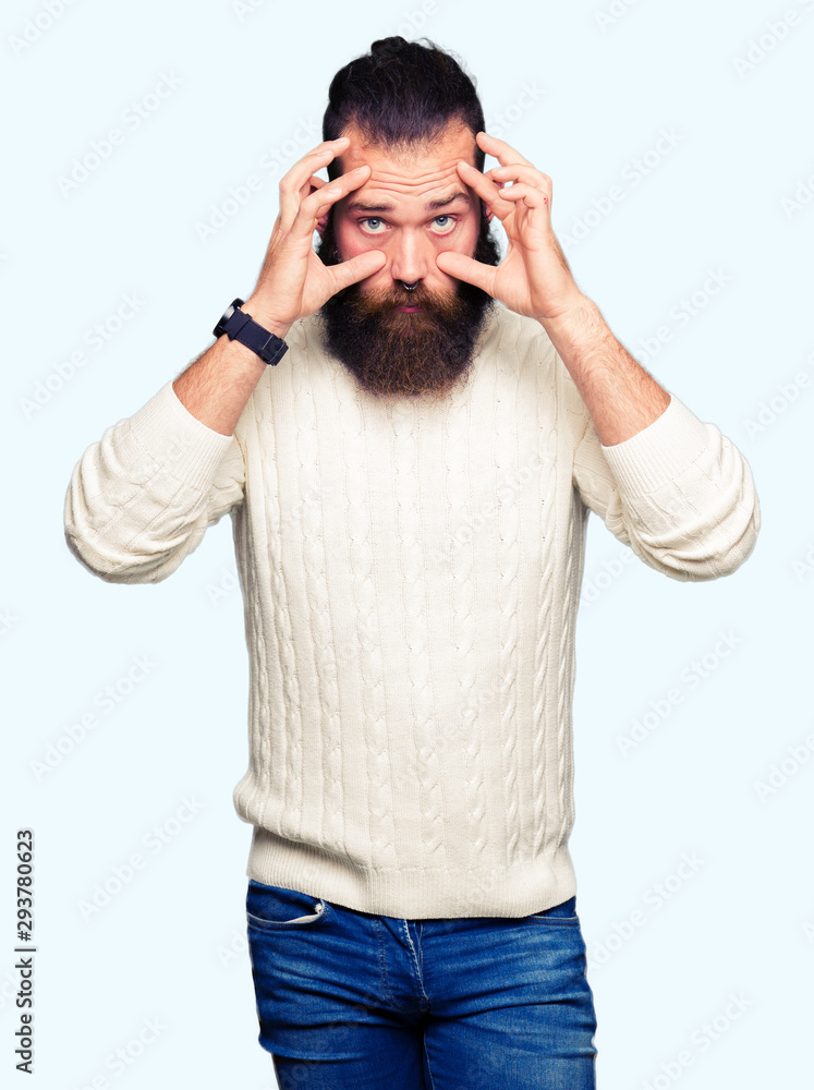 Young hipster man wearing winter sweater Trying to open eyes with fingers, sleepy and tired for morning fatigue Young hipster man wearing winter sweater Trying to open eyes with fingers, sleepy and tired for morning fatigue