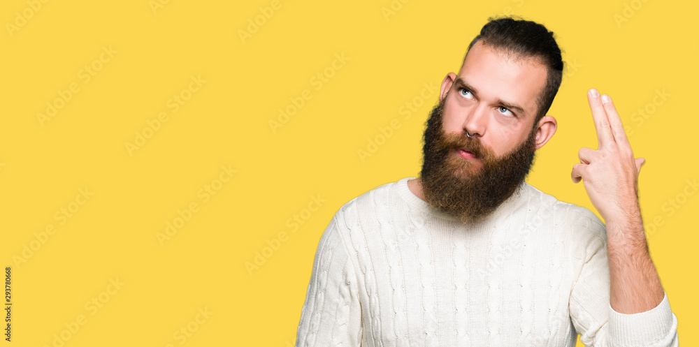 Young hipster man wearing winter sweater Shooting and killing oneself pointing hand and fingers to head, suicide gesture. Young hipster man wearing winter sweater Shooting and killing oneself pointing hand and fingers to head, suicide gesture.