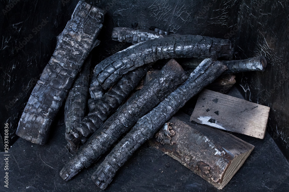 small burnt logs on a black background small burnt logs on a black background