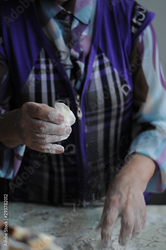 Woman molds Ukrainian dumplings.Ukrainian traditional dish