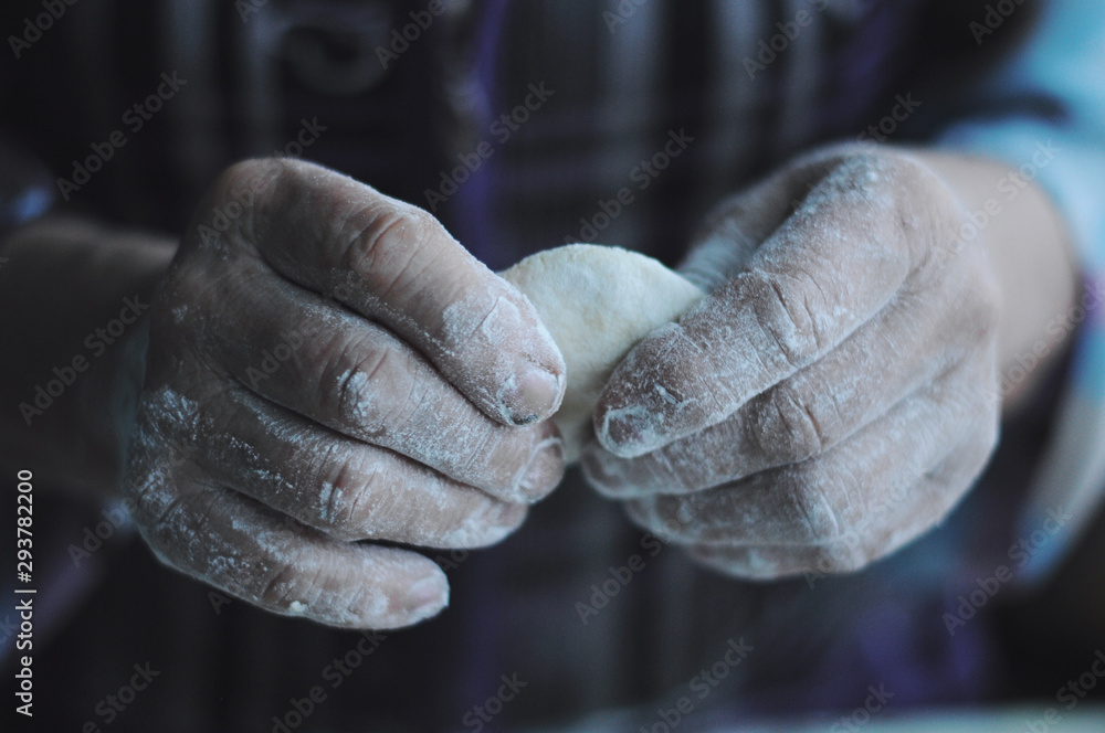 Woman molds Ukrainian dumplings.Ukrainian traditional dish Woman molds Ukrainian dumplings.Ukrainian traditional dish