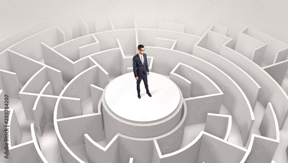 Businessman standing on the top a maze and looking through Businessman standing on the top a maze and looking through