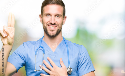 Schilderij op canvas Handsome doctor man wearing medical uniform over isolated background Swearing wi