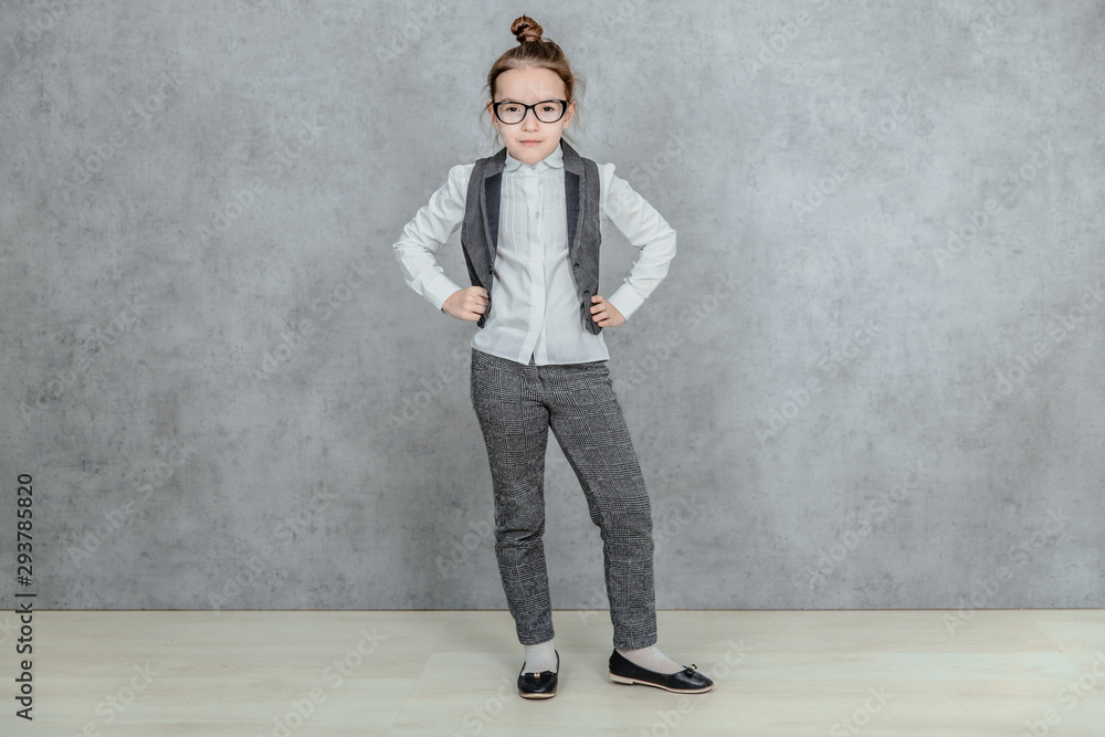 Full-length portrait of little business lady giving the case and attention gesturing, isolated on a gray background. Concept of leadership and success. Full-length portrait of little business lady giving the case and attention gesturing, isolated on a gray background. Concept of leadership and success.