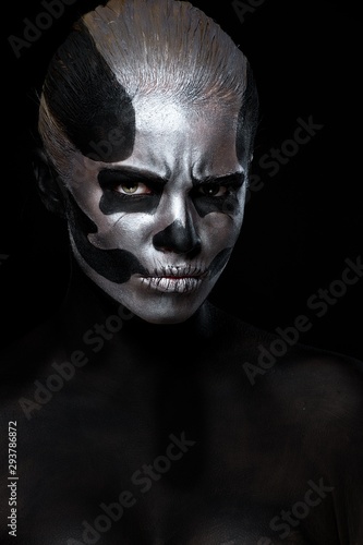 Halloween. Woman in day of the dead mask skull face art. Halloween face art on black background. Halloween make up.