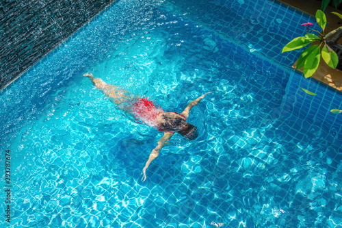 Cute girl is relaxing in the pool.