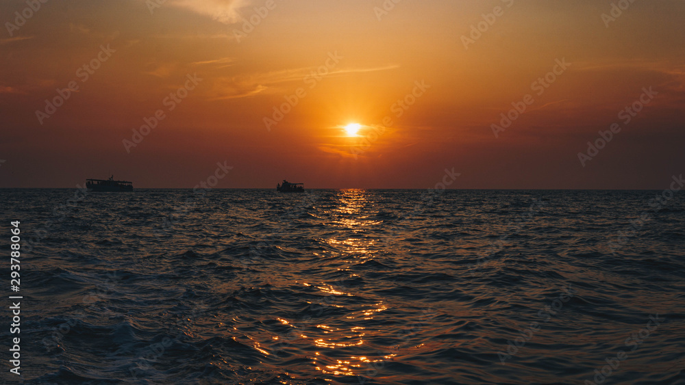 Fishing boat on the shore at sunset. A beautiful sunset in the background. Croatia, Brijuni Island Fishing boat on the shore at sunset. A beautiful sunset in the background. Croatia, Brijuni Island