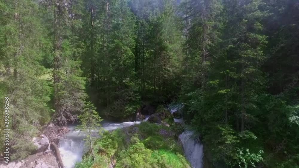Aerial shot of double waterfall in the nature between high fir trees in summer. Aerial shot of double waterfall in the nature between high fir trees in summer.