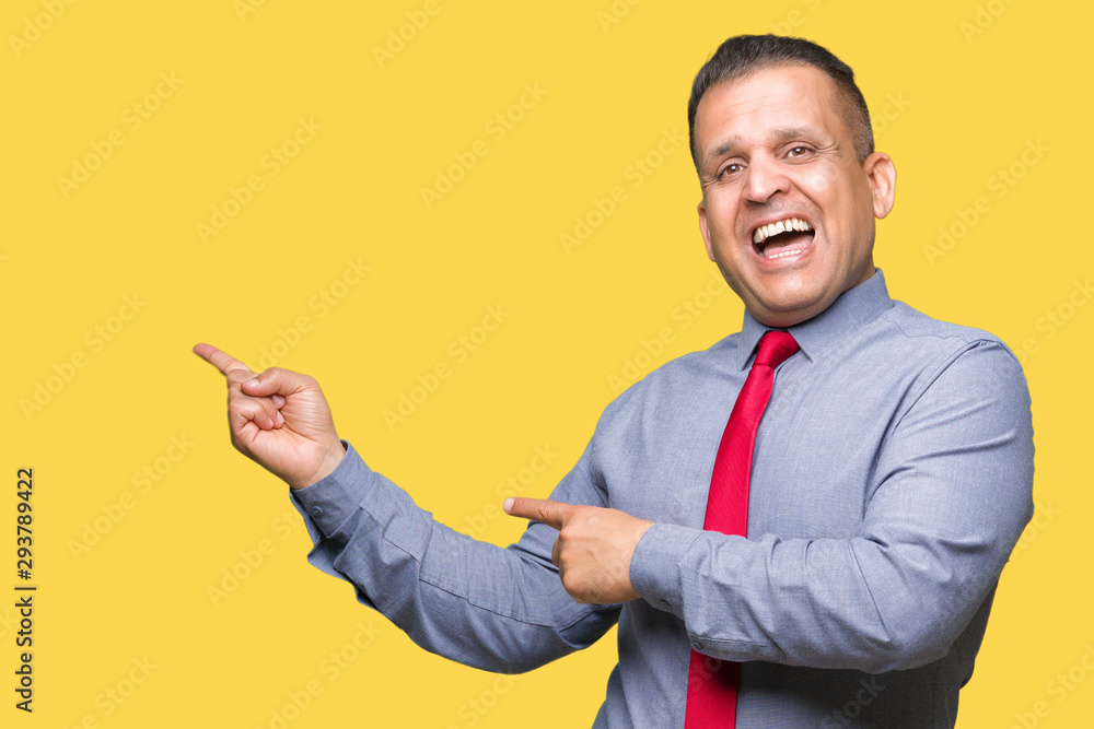 Middle age arab man wearing red tie over isolated background amazed and smiling to the camera while presenting with hand and pointing with finger. Middle age arab man wearing red tie over isolated background amazed and smiling to the camera while presenting with hand and pointing with finger.