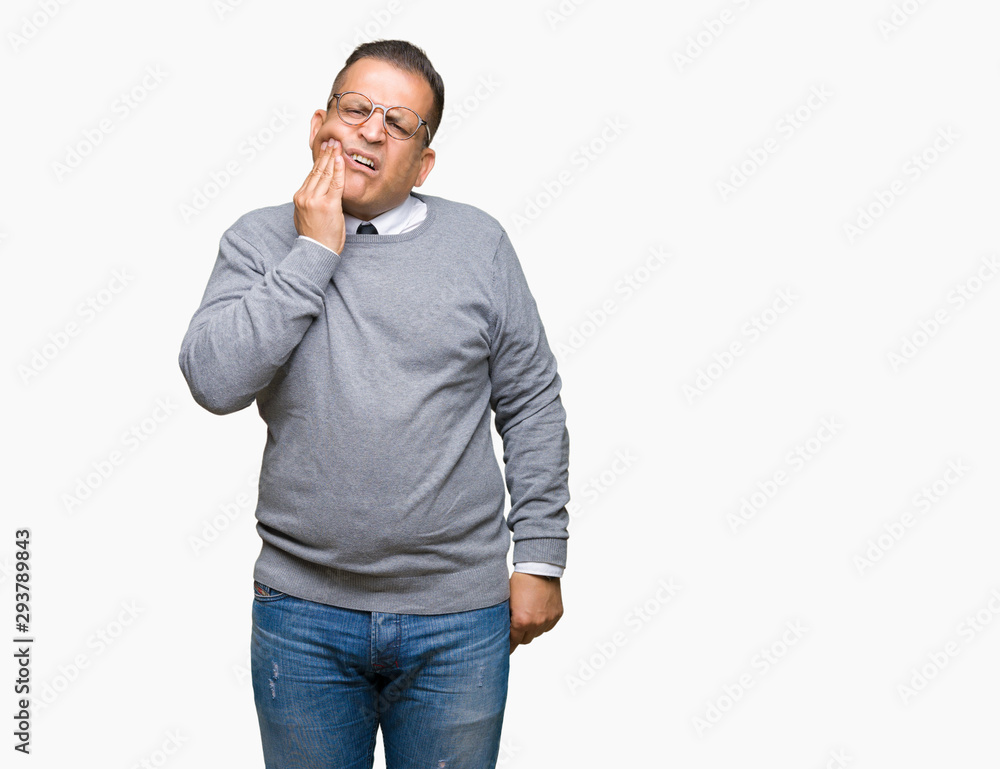 Fototapeta premium Middle age bussines arab man wearing glasses over isolated background touching mouth with hand with painful expression because of toothache or dental illness on teeth. Dentist concept.