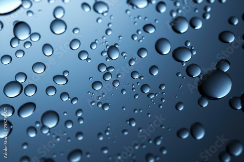 Close up Water droplets on a translucent black glass background with gradient