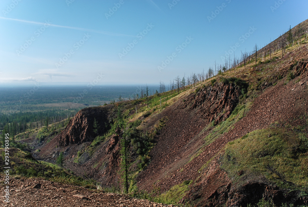 Naklejka premium Steep rocky mountains and rocks near the city of Norilsk, Russia. Dirty emissions from industrial plants turn nature into a desert.