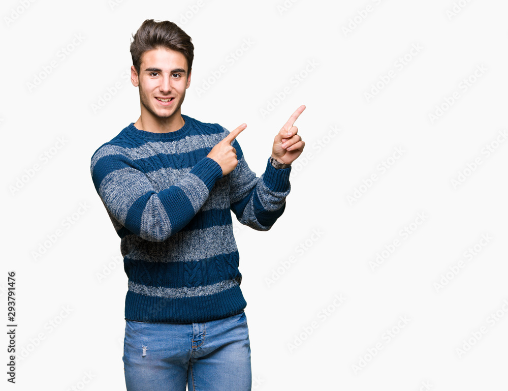 Young handsome man over isolated background smiling and looking at the camera pointing with two hands and fingers to the side. Young handsome man over isolated background smiling and looking at the camera pointing with two hands and fingers to the side.
