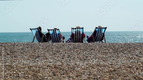 Four ladies are sitting and relaxing at the shores in England photo