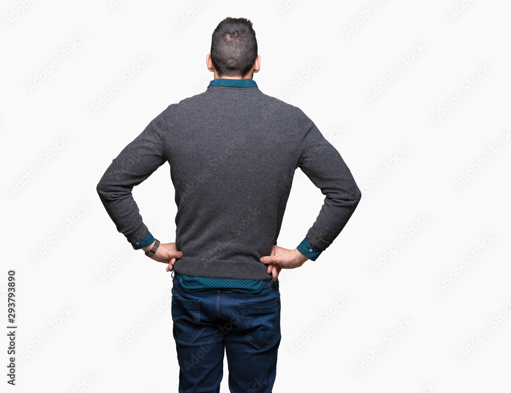 Young handsome man wearing glasses over isolated background standing backwards looking away with arms on body Young handsome man wearing glasses over isolated background standing backwards looking away with arms on body