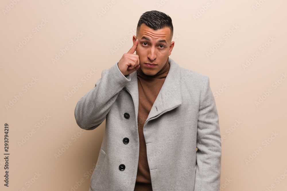 Young latin business man thinking about an idea Young latin business man thinking about an idea