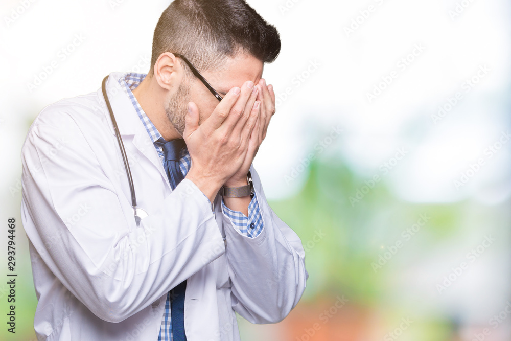 Handsome young doctor man over isolated background with sad expression covering face with hands while crying. Depression concept. Handsome young doctor man over isolated background with sad expression covering face with hands while crying. Depression concept.