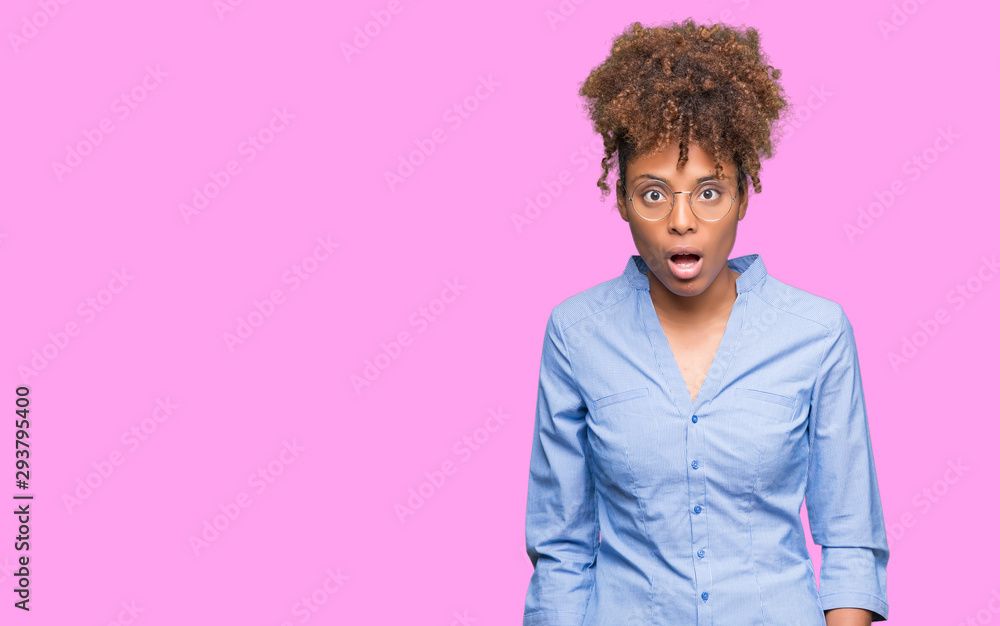 Beautiful young african american business woman over isolated background afraid and shocked with surprise expression, fear and excited face. Beautiful young african american business woman over isolated background afraid and shocked with surprise expression, fear and excited face.