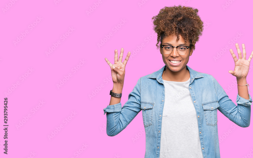 Beautiful young african american woman wearing glasses over isolated background showing and pointing up with fingers number nine while smiling confident and happy.