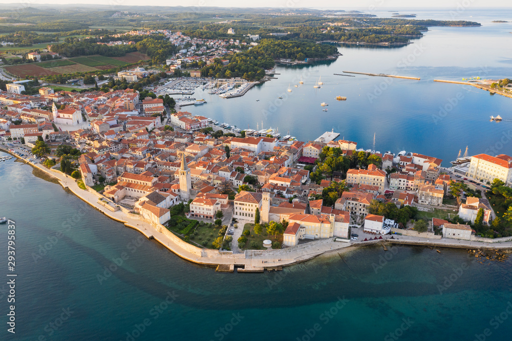 Sunrise over the old town in Croatia. The old town is Porec. It is located on a Peninsula surrounded by the Adriatic sea. The view from the top. Shooting from the copter. Copy space.