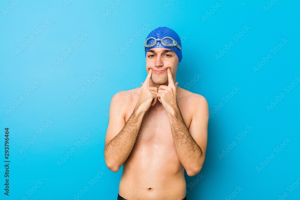 Young swimmer man doubting between two options.