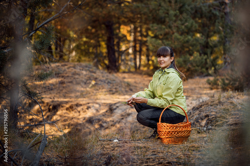 Beautiful girl in the autumn forest to gather mushrooms. Stay in the fresh air.