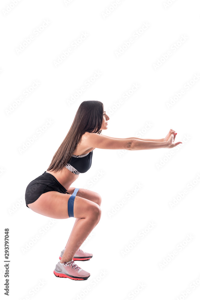 Side view of fitness woman doing leg exercises squatting with resistance bands. Full body isolated on white background. 