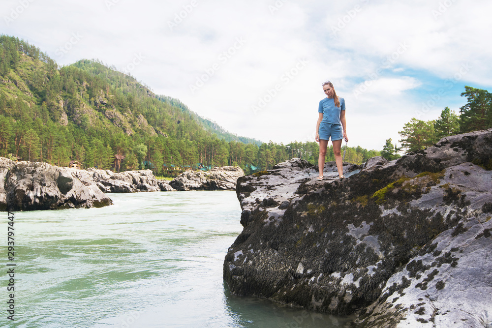 Woman resting at river in Altai Mountains territory