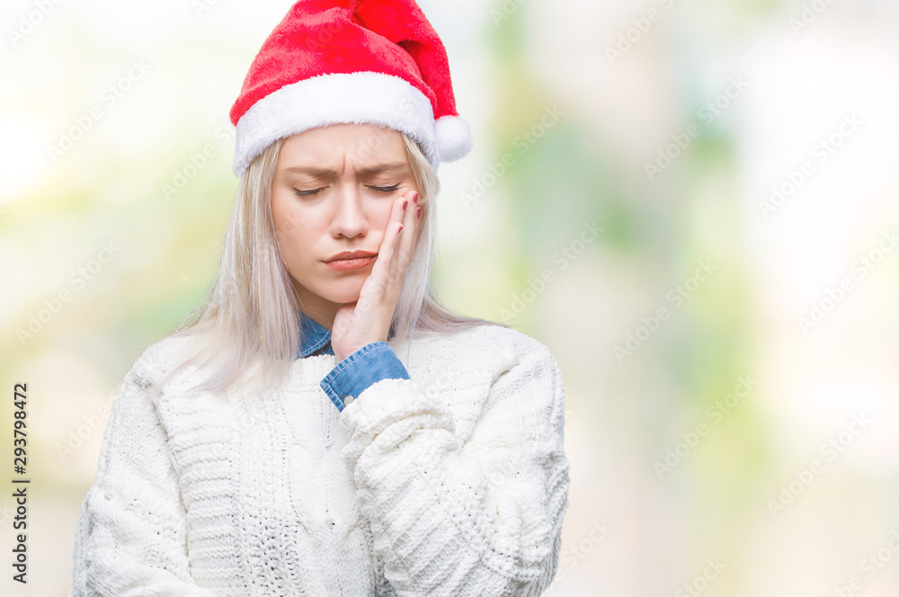 Young blonde woman wearing christmas hat over isolated background thinking looking tired and bored with depression problems with crossed arms. Young blonde woman wearing christmas hat over isolated background thinking looking tired and bored with depression problems with crossed arms.